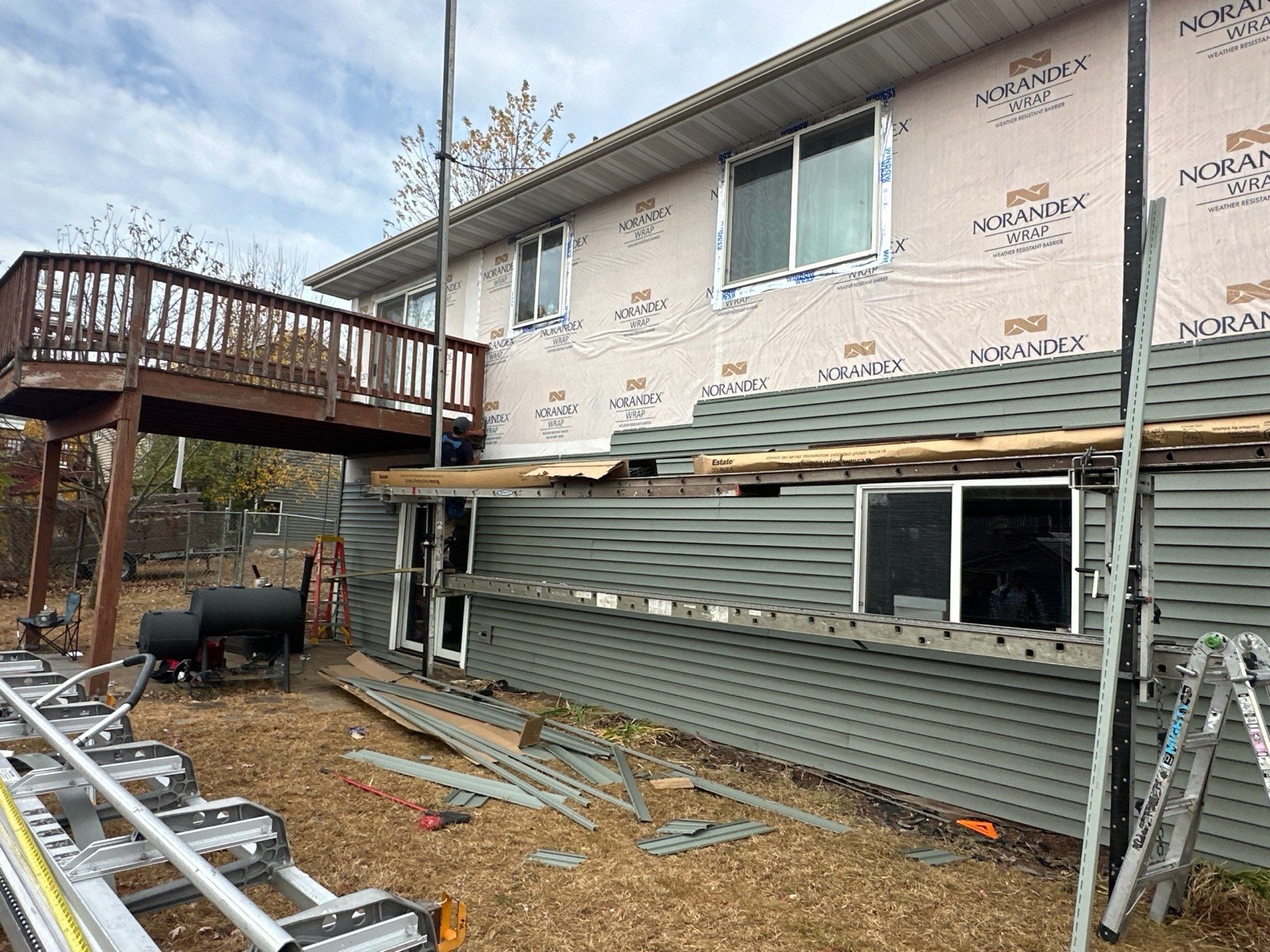 Exterior siding replacement with house wrap and flashing
